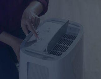 Woman Changing Settings on Refrigerant Dehumidifier