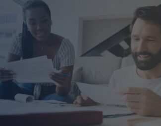 Couple Checking Bills For Home Budget