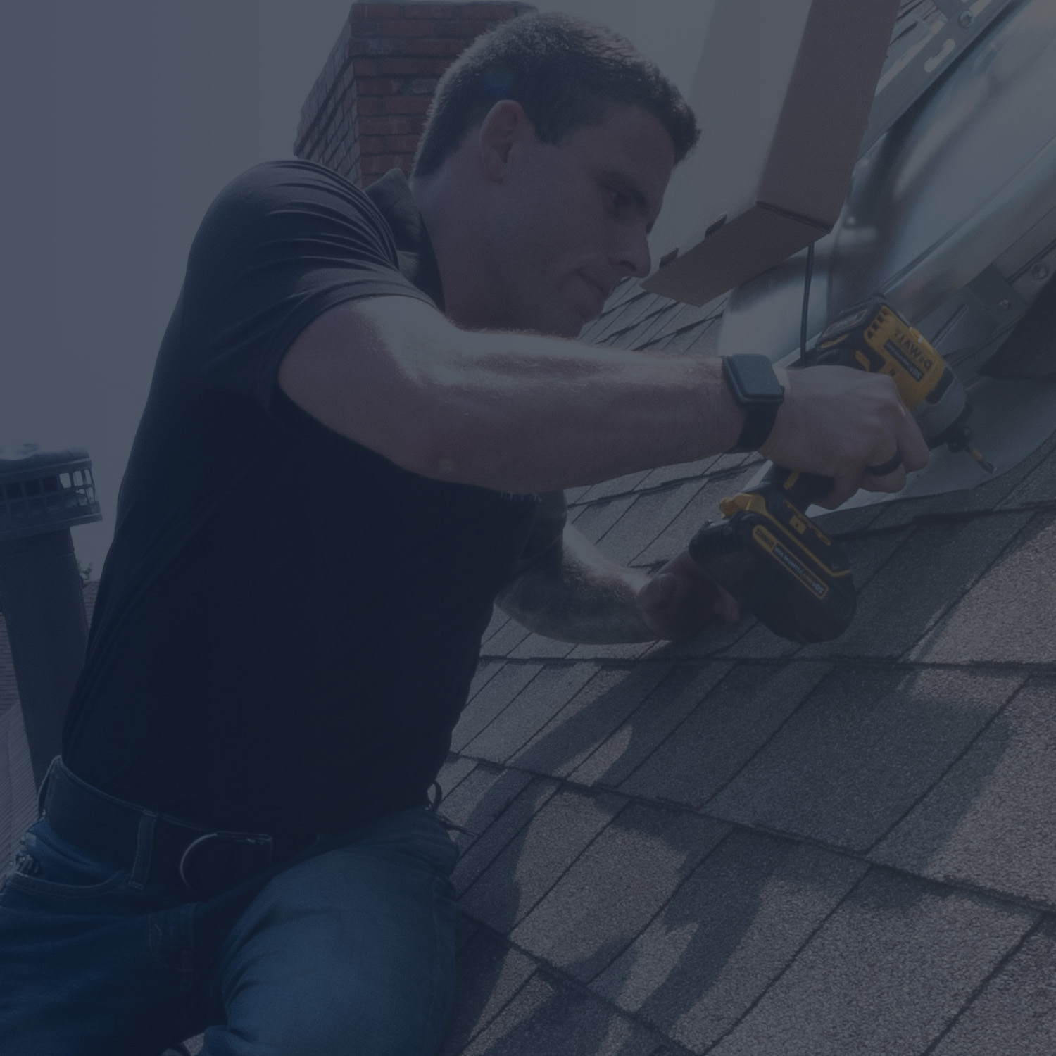 Man Installing the Exterior Side of an Attic Fan