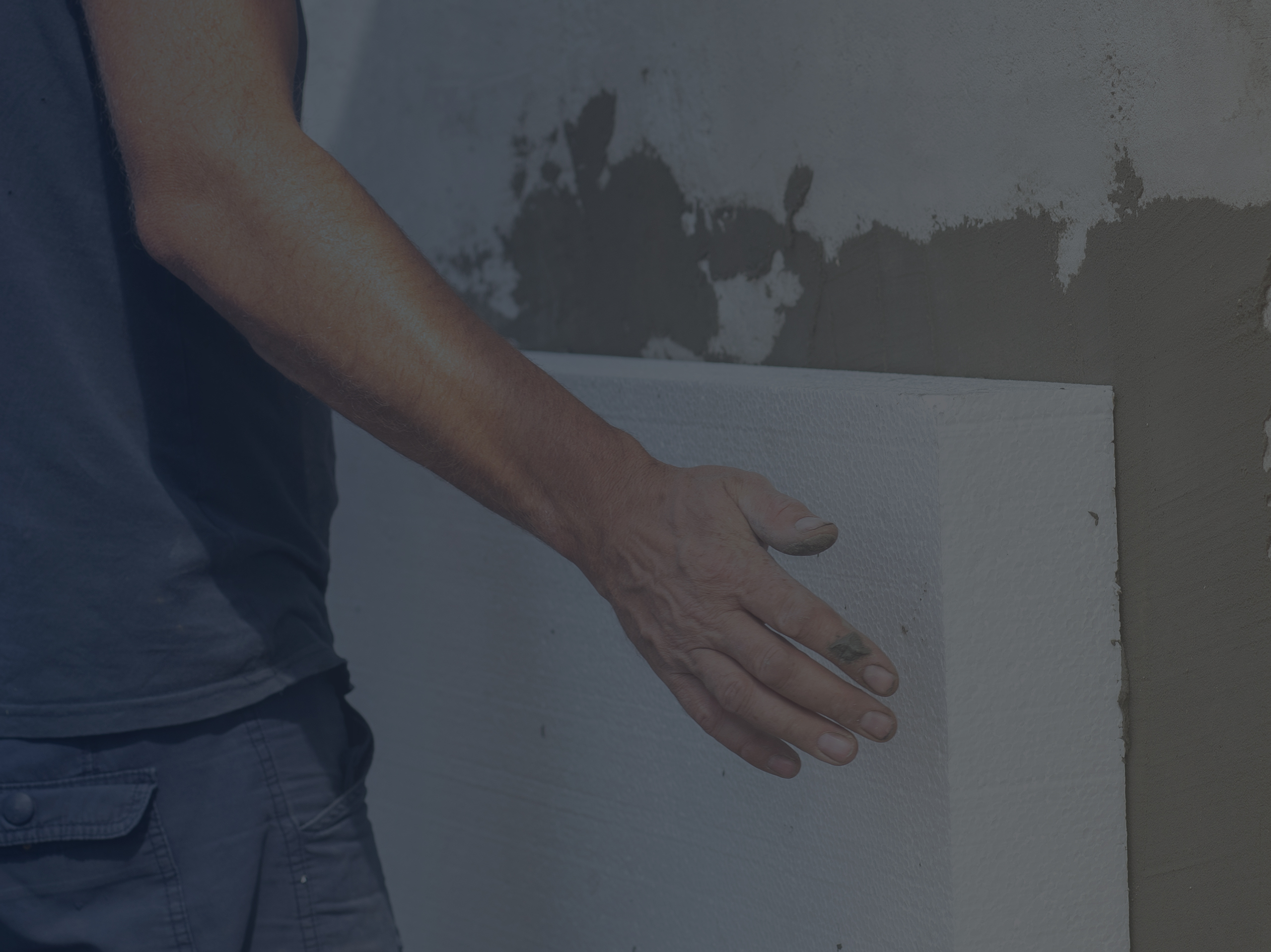 Man insulating a Facade Wall with Styrofoam Sheets