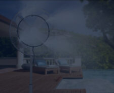 Pedestal Misting Fan Releasing Mist on Pool Deck