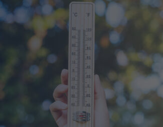 Woman Holding Thermometer Outdoors to Check the Temperature