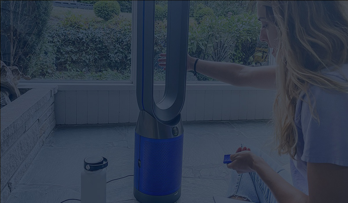 Woman Operating a Dyson Tower Fan