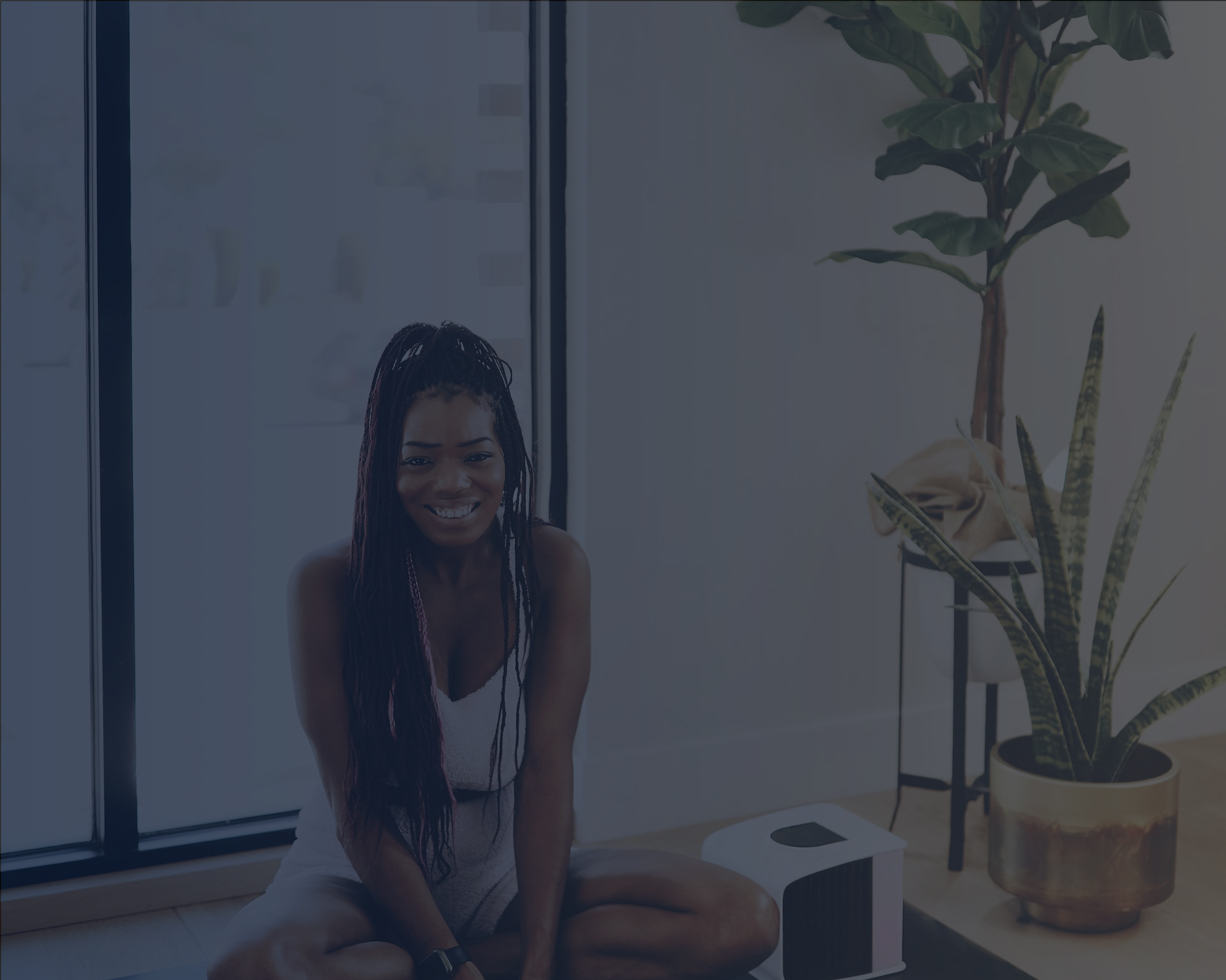 Woman Sitting on a Yoga Mat next to an Evaporative Cooler