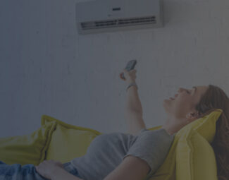 Young Woman Relaxing on Couch and Pointing Remote Control toward AC