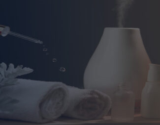 Aroma Oil Diffuser among Towels and Essential Oils