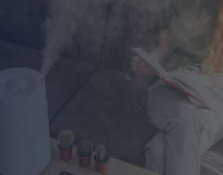 Woman Reading a Book next to a Single-Room Humidifier