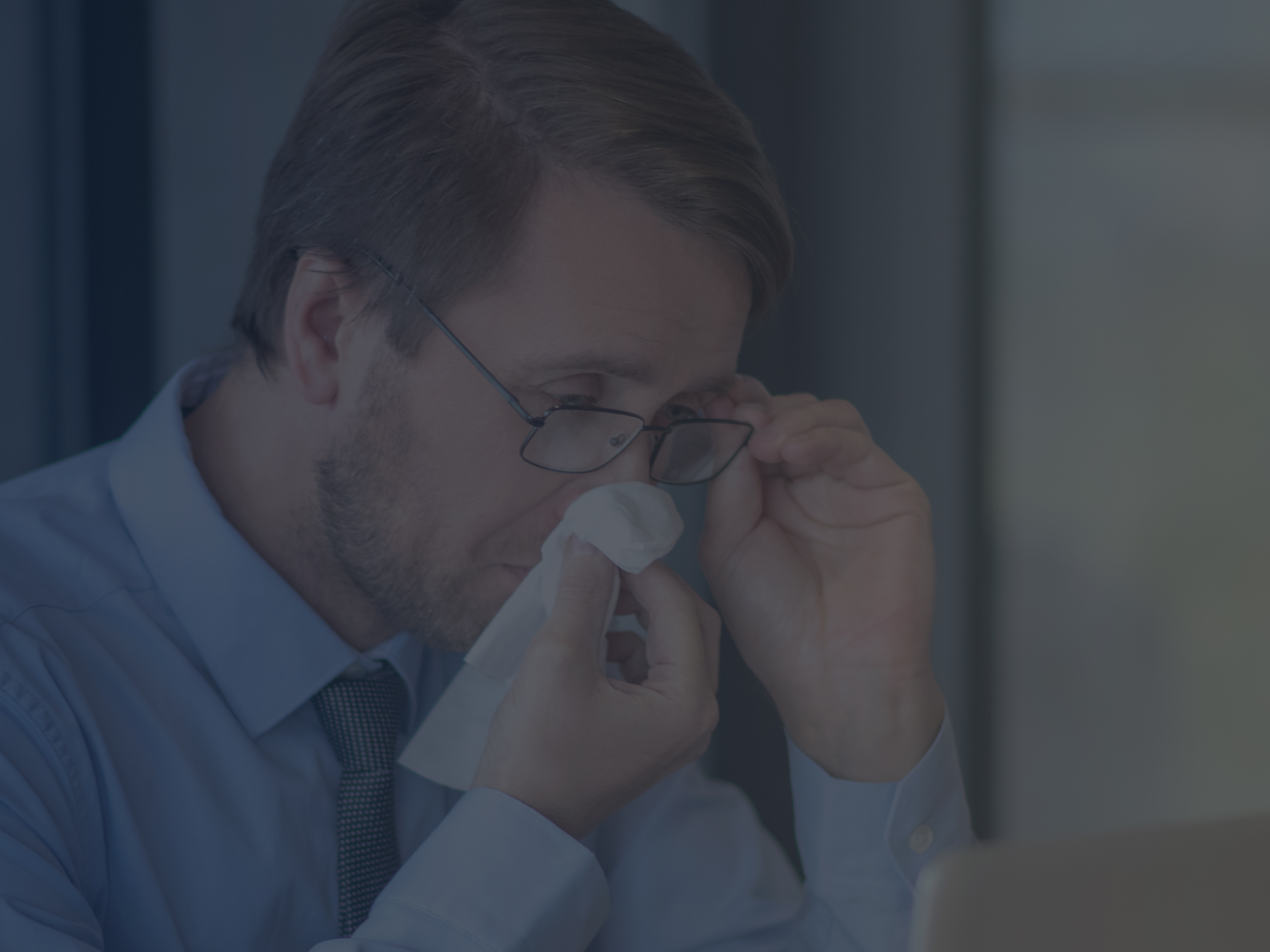 Office Worker Dealing with Seasonal Allergy in the Office