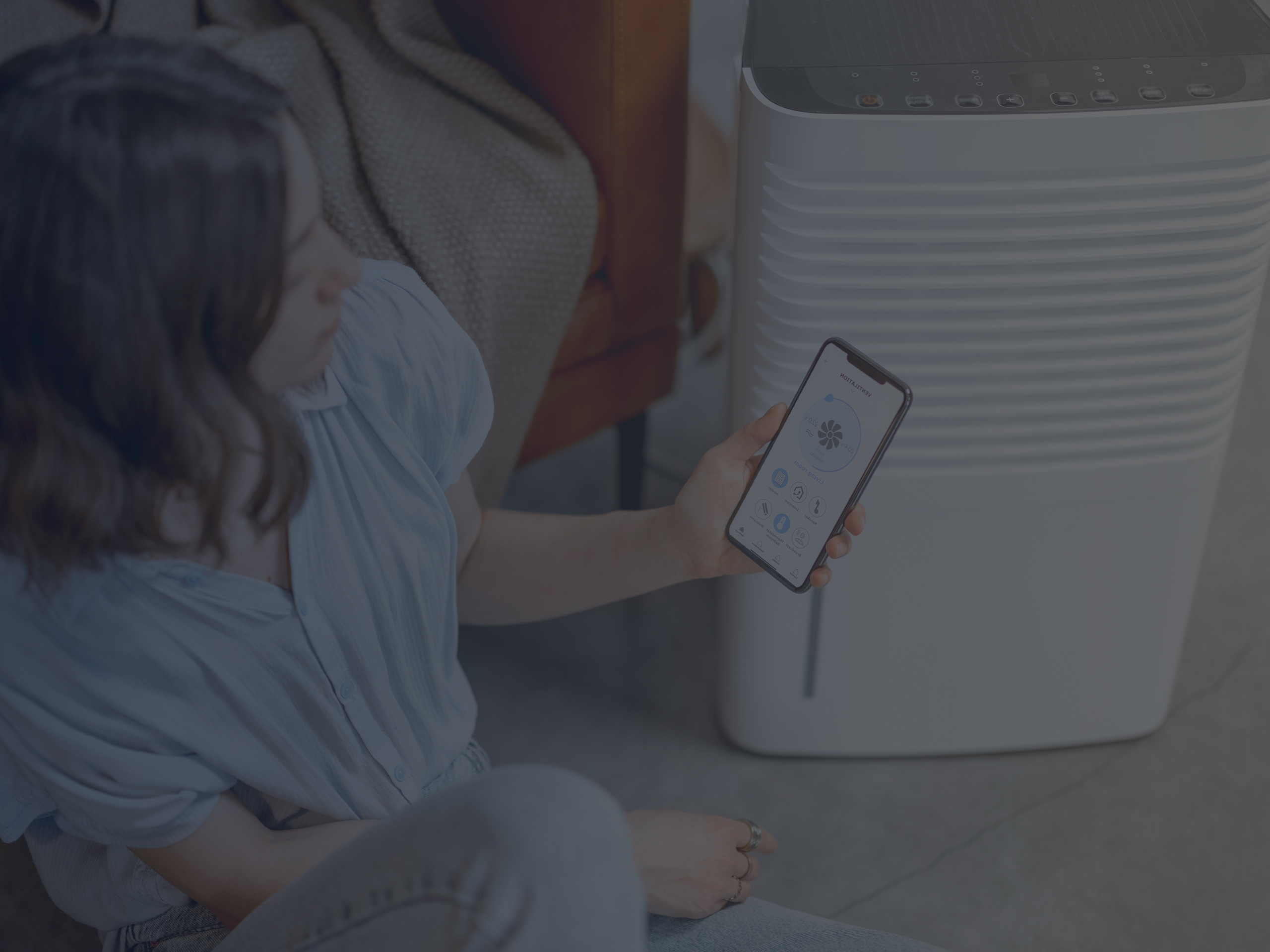 Woman Controlling Smart Air Purifier with Smartphone